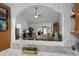 An arched opening from the kitchen shows the bright and spacious living room with access to an outdoor patio at 2438 Hansard Dr, North Charleston, SC 29406
