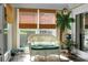 Bright sunroom with wicker seating, palm tree mural, and ample sunlight, a tranquil retreat at 2438 Hansard Dr, North Charleston, SC 29406
