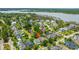An aerial shot of the neighborhood showcases a pond, waterfront views, and the location of the featured home at 2800 River Vista Way, Mount Pleasant, SC 29466