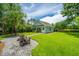 Lush backyard featuring a patio, palm tree, green lawn, and pathway to the house at 2800 River Vista Way, Mount Pleasant, SC 29466