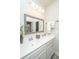 Bright bathroom with double sinks, framed mirror, white cabinets, and ample lighting at 2800 River Vista Way, Mount Pleasant, SC 29466