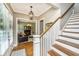 Inviting entryway with hardwood floors, staircase, and a view of the living room through an arched doorway at 2800 River Vista Way, Mount Pleasant, SC 29466