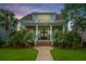 Inviting two-story home with manicured lawn, featuring a welcoming front porch with decorative columns at 2800 River Vista Way, Mount Pleasant, SC 29466