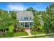 Inviting two-story home features a charming front porch and a beautifully landscaped front yard with mature trees at 2800 River Vista Way, Mount Pleasant, SC 29466
