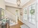 Elegant foyer features hardwood floors, staircase, chandelier, and double entry doors for bright natural light at 2800 River Vista Way, Mount Pleasant, SC 29466
