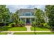 Inviting home with a covered front porch, complemented by lush green lawns and mature landscaping, offering a warm curb appeal at 2800 River Vista Way, Mount Pleasant, SC 29466