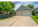 Two-car garage with ample parking space and an adjacent black fence at 2800 River Vista Way, Mount Pleasant, SC 29466