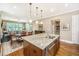 Open-concept kitchen with a central island, seamlessly flowing into the dining and living areas at 2800 River Vista Way, Mount Pleasant, SC 29466