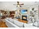 Inviting open-concept living room features a fireplace, built-in shelves, and seamless access to the adjacent kitchen and dining at 2800 River Vista Way, Mount Pleasant, SC 29466