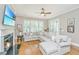Cozy living room with hardwood floors, a fireplace, a large window, and a comfortable sectional sofa at 2800 River Vista Way, Mount Pleasant, SC 29466