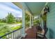 Charming front porch with rocking chairs, columns, and a view of the neighborhood street at 2800 River Vista Way, Mount Pleasant, SC 29466