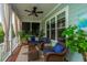 Relaxing screened porch featuring comfortable seating, ceiling fan, and exterior views at 2800 River Vista Way, Mount Pleasant, SC 29466