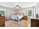 Comfortable bedroom with hardwood floors, area rug, and natural light from the surrounding windows at 2942 Foxhall Rd, Charleston, SC 29414