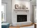 Close-up of the painted brick fireplace and hearth with a white mantel displaying decorative items at 2942 Foxhall Rd, Charleston, SC 29414