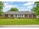 Charming brick home featuring a well-maintained front yard and a bright blue front door at 2942 Foxhall Rd, Charleston, SC 29414