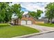 Spacious two-car garage with an extended driveway, complemented by mature trees and landscaping at 2942 Foxhall Rd, Charleston, SC 29414