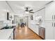 Bright, all-white kitchen with modern appliances, granite countertops, and hardwood floors at 2942 Foxhall Rd, Charleston, SC 29414