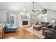 Bright living room with a brick fireplace, vaulted ceilings, and open access to the backyard patio at 2942 Foxhall Rd, Charleston, SC 29414