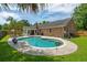 Inviting backyard oasis featuring a sparkling pool, lush greenery, and an outdoor living space at 2942 Foxhall Rd, Charleston, SC 29414