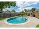 Large backyard pool with lounge chairs, green trees, brick house, and fenced perimeter at 2942 Foxhall Rd, Charleston, SC 29414