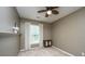 Neutral bedroom features a ceiling fan, a window with blinds, and a decorative cabinet at 3012 Candela Grove Dr, Charleston, SC 29414