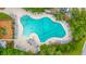 Aerial view of a large community pool area with plenty of seating, lush trees, and a nearby playground at 3012 Candela Grove Dr, Charleston, SC 29414
