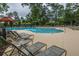 A refreshing community pool with lounge chairs and a fountain feature, perfect for relaxing and socializing at 3012 Candela Grove Dr, Charleston, SC 29414