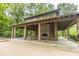 Community gathering space with a brick fireplace and picnic tables, ideal for outdoor events and socializing at 3012 Candela Grove Dr, Charleston, SC 29414