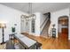 Charming dining area featuring modern lighting, wood floors, and a convenient layout adjacent to the staircase and entryway at 3012 Candela Grove Dr, Charleston, SC 29414