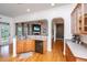Bright and open kitchen with wood floors, wood cabinets and granite countertops at 3012 Candela Grove Dr, Charleston, SC 29414