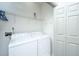 Bright laundry room with washer, dryer, and storage shelving for easy chores at 3012 Candela Grove Dr, Charleston, SC 29414