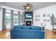Comfortable living room featuring a fireplace with TV and a cozy blue sofa at 3012 Candela Grove Dr, Charleston, SC 29414