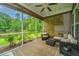 Inviting screened porch with comfortable seating overlooking lush backyard and pond view at 3012 Candela Grove Dr, Charleston, SC 29414