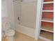 Bathroom with a white bathtub and shower combination next to a linen closet at 3034 Maybank Hwy, Johns Island, SC 29455