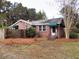 Brick home showcasing awnings, well-maintained front yard, and classic architectural details at 3034 Maybank Hwy, Johns Island, SC 29455