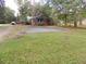 Brick house with ample parking space on a large lot, enclosed by trees and a fence at 3034 Maybank Hwy, Johns Island, SC 29455