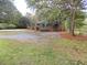 Single-story brick house with green awning and mature trees surrounding the property at 3034 Maybank Hwy, Johns Island, SC 29455