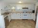 Bright kitchen with white cabinets, stainless steel appliances, and durable flooring at 3034 Maybank Hwy, Johns Island, SC 29455