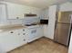 Bright kitchen with white cabinets, stainless steel refrigerator, and gas range at 3034 Maybank Hwy, Johns Island, SC 29455