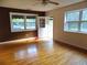 Cozy living room with wood floors, large windows, modern ceiling fan, and backyard view at 3034 Maybank Hwy, Johns Island, SC 29455