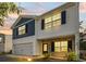 Two-story home with blue and white siding, stone accents, a two-car garage, and well-maintained landscaping at 304 Torslanda Ln, Summerville, SC 29486