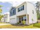 Two-story home featuring blue and white siding, a stone facade, a two-car garage, and a well-manicured lawn at 304 Torslanda Ln, Summerville, SC 29486
