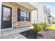 Inviting townhome featuring a stone facade, a charming front door, and manicured landscaping at 304 Torslanda Ln, Summerville, SC 29486