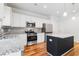 Charming kitchen with stainless steel appliances, granite countertops, and wood-look floors at 304 Torslanda Ln, Summerville, SC 29486