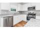 Well-lit kitchen featuring granite countertops, stainless steel appliances, and white cabinetry at 304 Torslanda Ln, Summerville, SC 29486