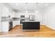 Bright kitchen with island, white cabinets, stainless steel appliances and granite countertops at 304 Torslanda Ln, Summerville, SC 29486