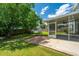 The home features a lush backyard with a screened in porch and mature trees at 311 Aberdeen Cir, Summerville, SC 29483