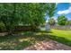 Backyard with lush lawn, mature trees, wooden fence, and a storage shed at 311 Aberdeen Cir, Summerville, SC 29483