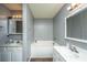 Neutral bathroom showcasing white cabinetry, soaking tub and updated vanity with modern fixtures at 311 Aberdeen Cir, Summerville, SC 29483