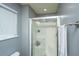 Bathroom with glass-doored shower and neutral paint; a clean and bright aesthetic at 311 Aberdeen Cir, Summerville, SC 29483